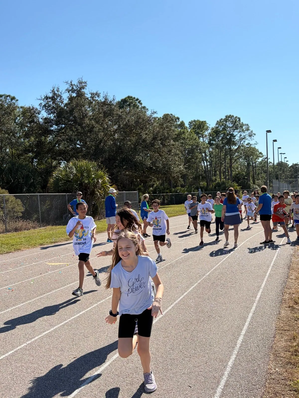 Students running, grade-level competitions, volunteers, cheering