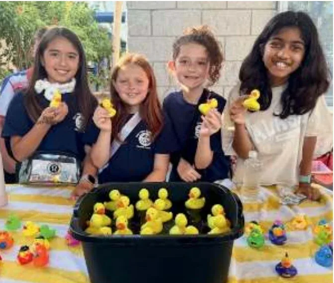 Students at the Pine View Fair: a rubber duck booth, the inflatables, and the dunk tank