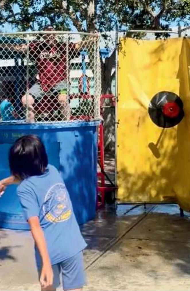 Students at the Pine View Fair: a rubber duck booth, the inflatables, and the dunk tank