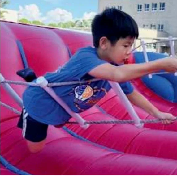 Students at the Pine View Fair: a rubber duck booth, the inflatables, and the dunk tank